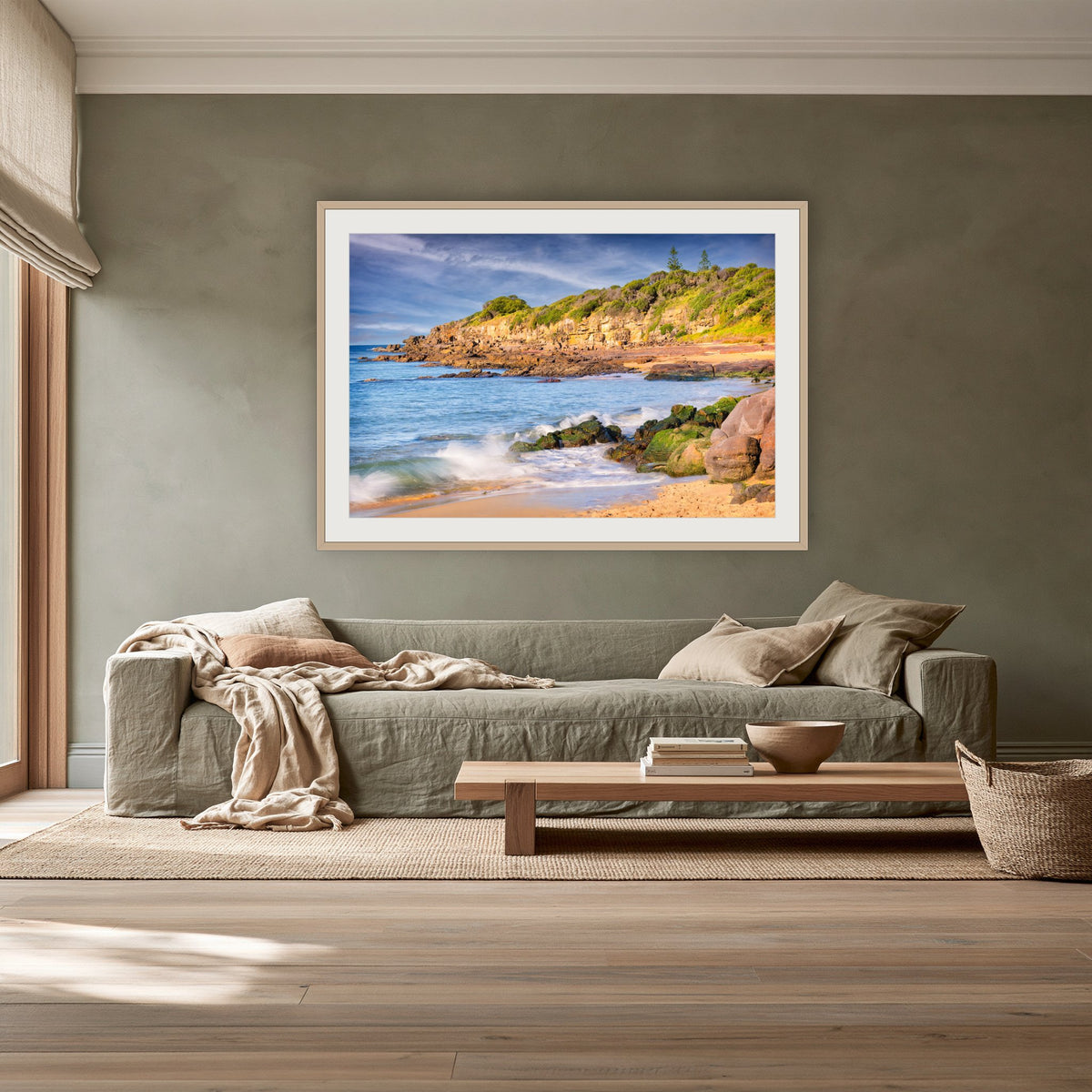 Short Point Cliffs framed print in oak with a white mat, above a sage linen sofa in a lounge room