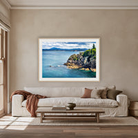 Twofold Bay Rocky Cliffs & Mt Imlay framed print in oak with a white mat, above an oatmeal linen sofa in a lounge room