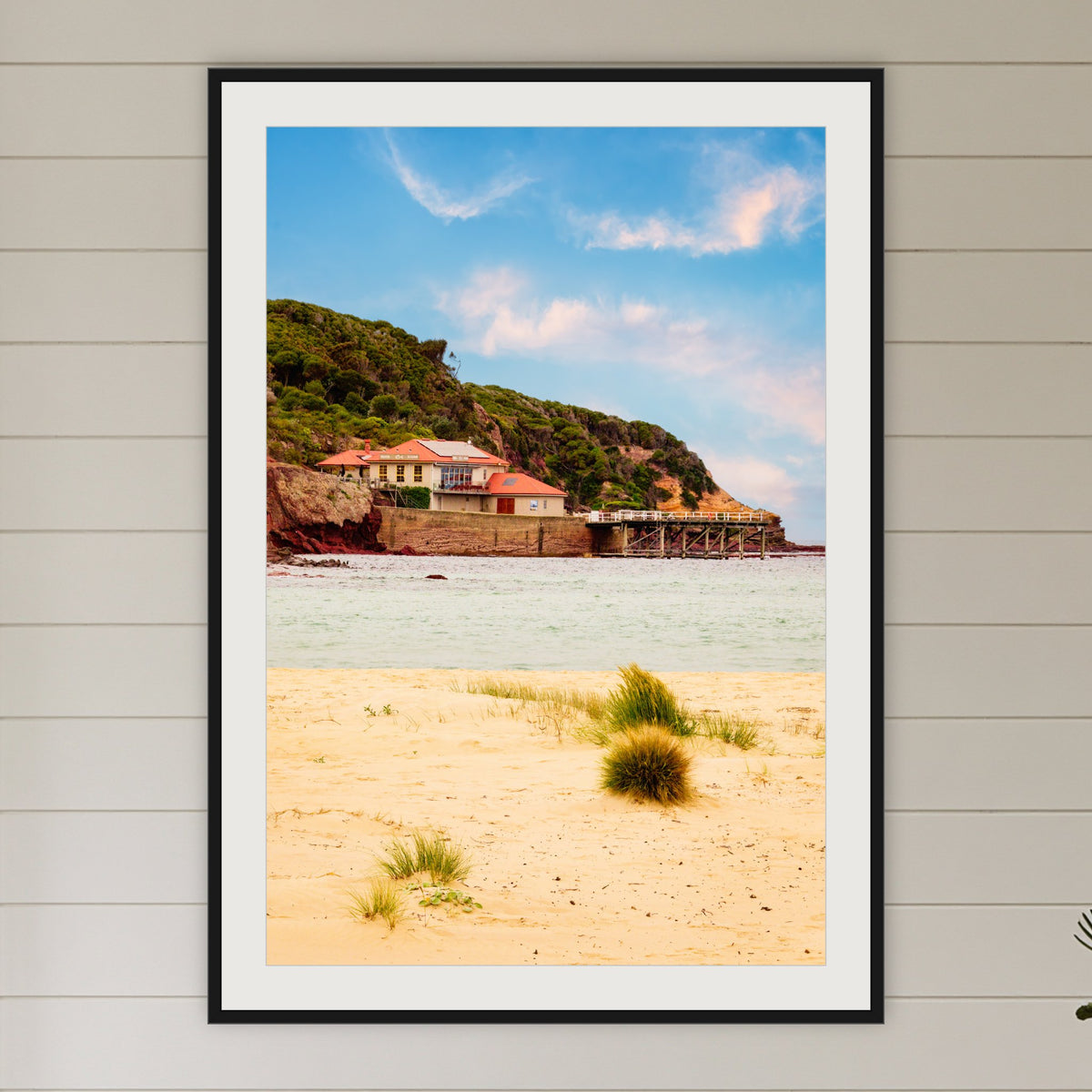 Merimbula Wharf from Main Beach framed print in black with a white mat, in a coastal bedroom
