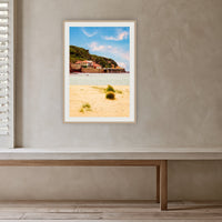 Merimbula Wharf from Main Beach framed print in oak with a white mat, in a plaster-walled hallway