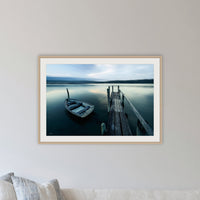 Little Boat at Fishpen Jetty Artistic Treatment framed print in oak with a white mat, in a lounge room