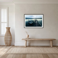 Little Boat at Fishpen Jetty Artistic Treatment framed print in black with a white mat, in a hallway