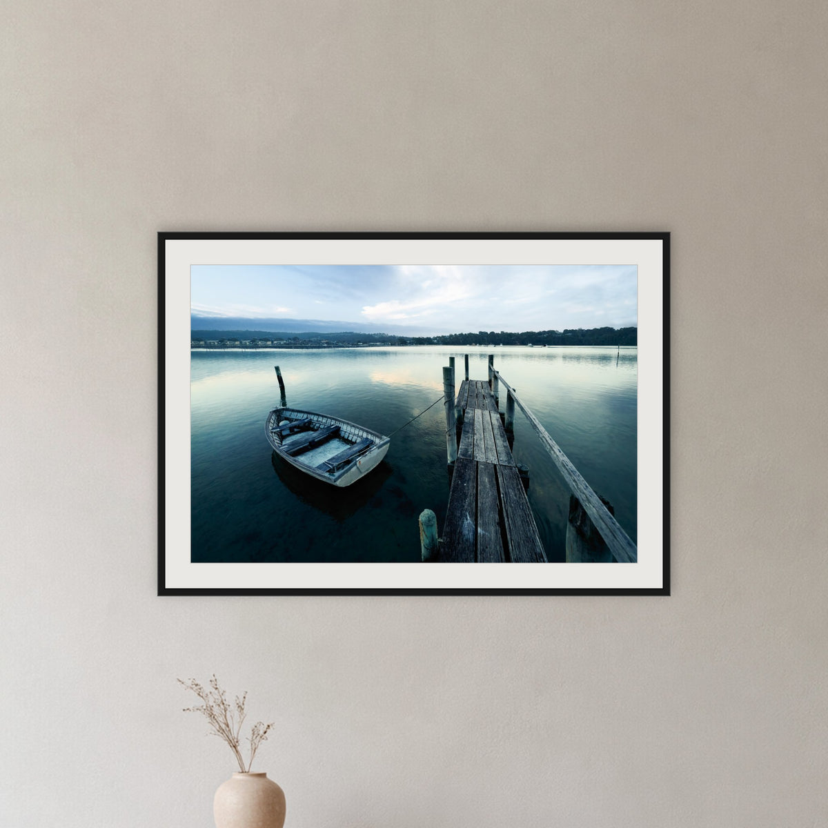 Little Boat at Fishpen Jetty framed print in black with a white mat, in a hallway