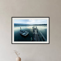 Little Boat at Fishpen Jetty framed print in black with a white mat, in a hallway