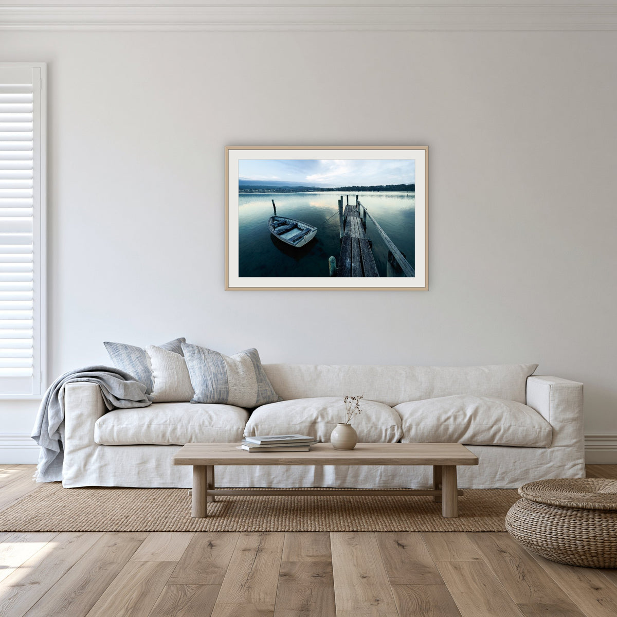 Little Boat at Fishpen Jetty framed print in oak with a white mat, in a lounge room