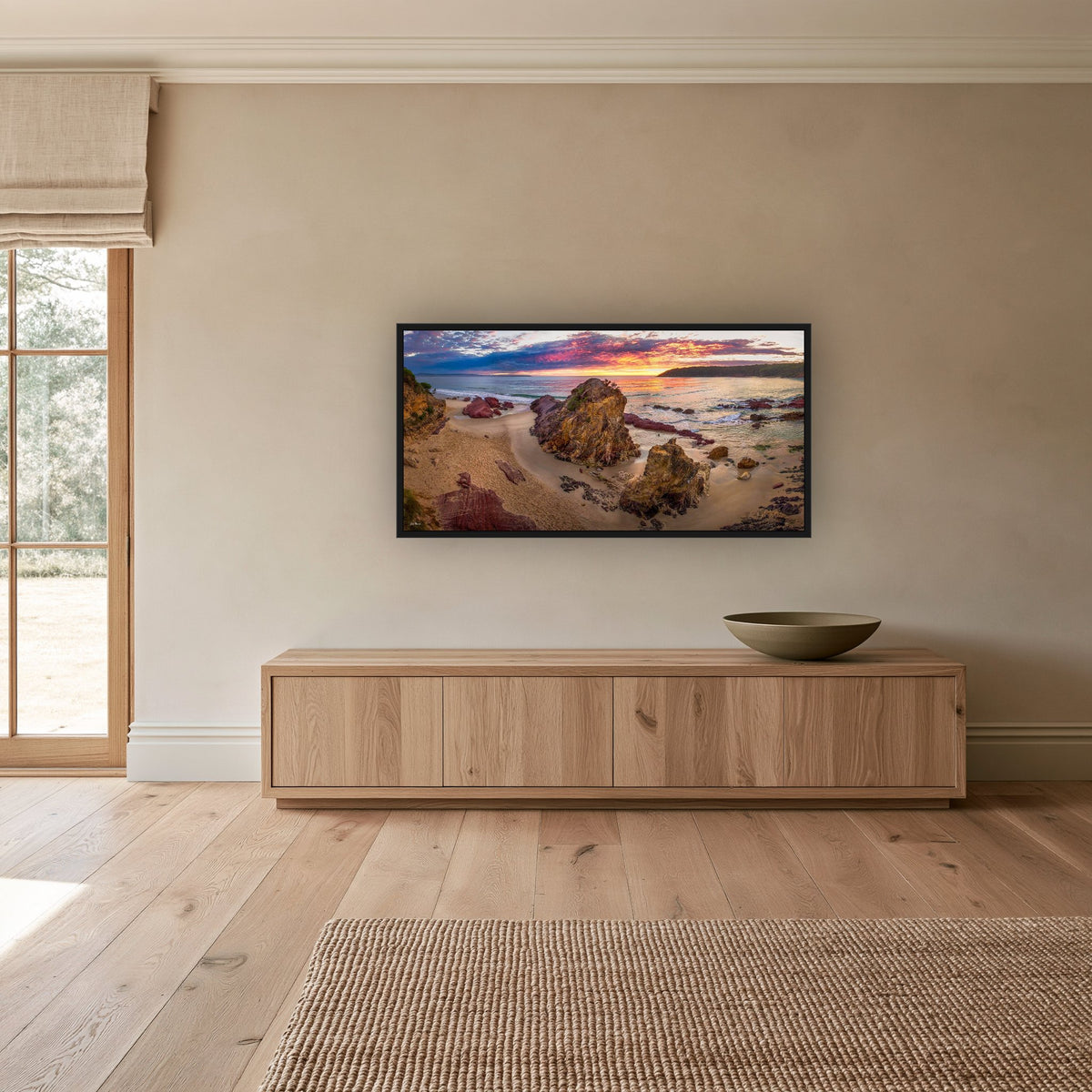 Pambula Beach Sunrise wide panorama in a black frame above a long oak sideboard — wall art, Sapphire Coast NSW