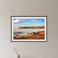 Short Point Sunrise framed print in black with a white mat, in a hallway