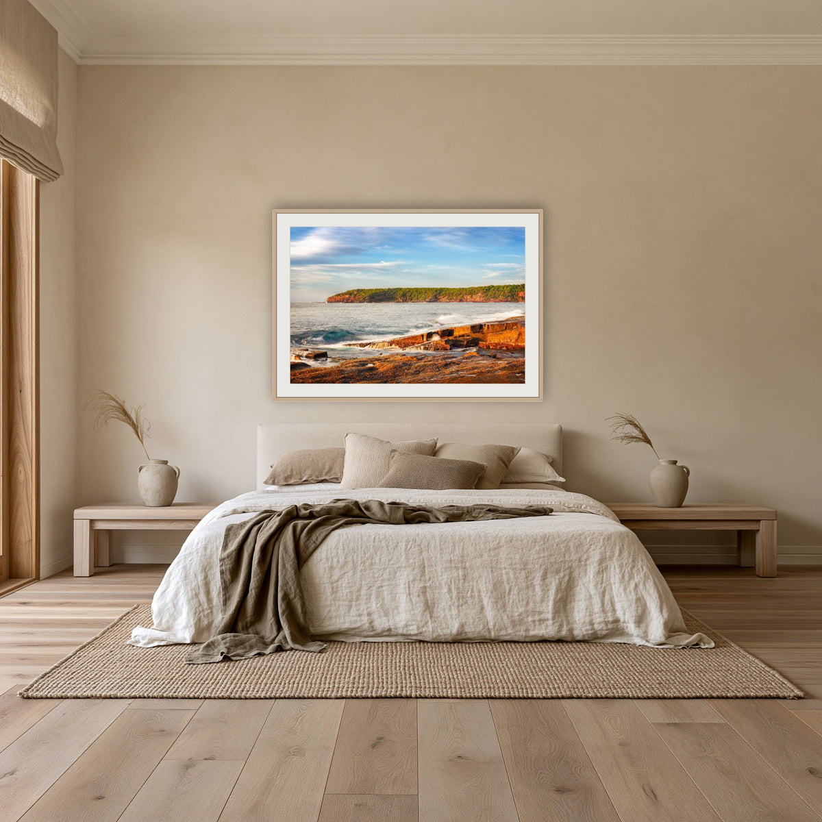 Short Point Sunrise framed print in oak with a white mat, above an oatmeal linen bed in a bedroom