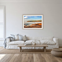 Short Point Sunrise framed print in oak with a white mat, in a lounge room