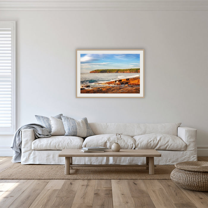 Short Point Sunrise framed print in oak with a white mat, in a lounge room