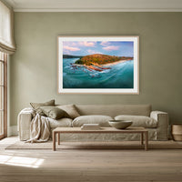 Pambula Beach Seascape framed print in oak with a white mat, above a linen sofa against a sage wall in a lounge room