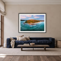 Pambula Beach Seascape framed print in black with a white mat, above a navy linen sofa in a lounge room
