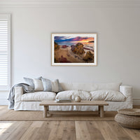 Pambula Beach Sunrise framed print in oak with a white mat, in a lounge room