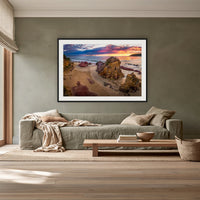 Pambula Beach Sunrise framed print in black with a white mat, above a sage linen sofa in a lounge room