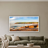 Short Point Sunrise wide panorama in a white frame above a sage linen sofa — wall art, Merimbula NSW
