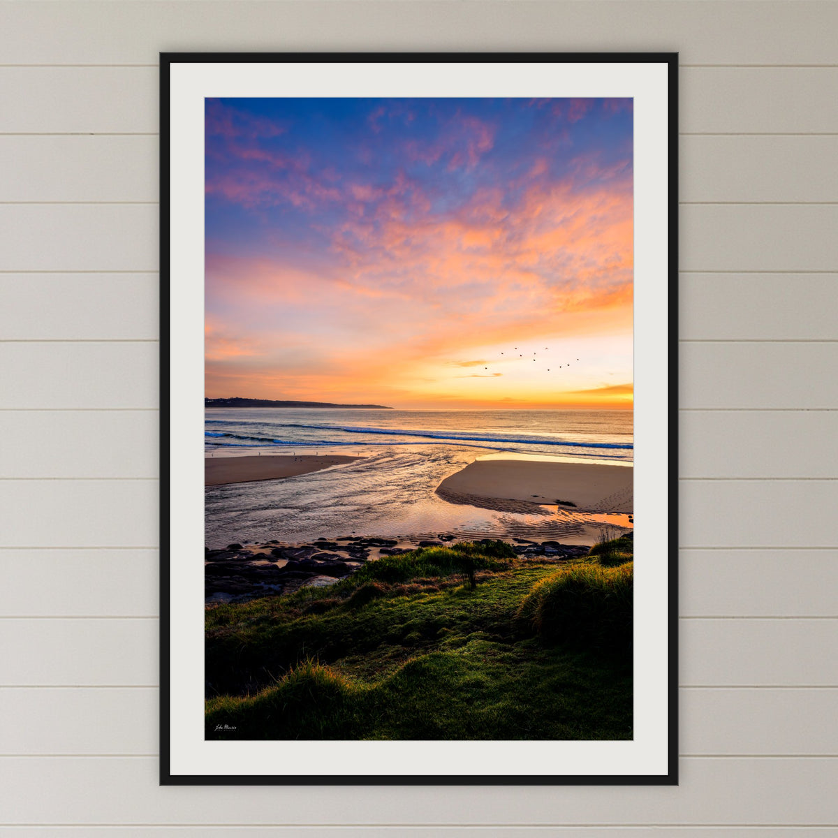 Short Point Back Lake framed print in black with a white mat, in a coastal bedroom