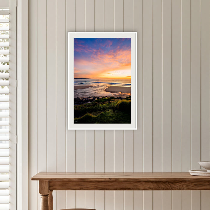 Short Point Back Lake framed print in white with a mat, on a panelled hallway wall