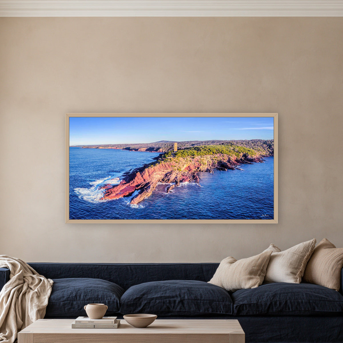 Ben Boyd Tower at Golden Hour wide panorama in an oak frame above a navy linen sofa — wall art, Eden NSW