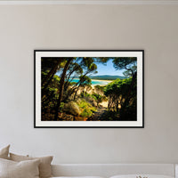 Wallagoot Lake framed print in black with a white mat on a lounge room wall
