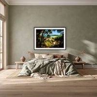 Wallagoot Lake framed print in black with a white mat, above a khaki linen bed against a green-grey wall in a bedroom