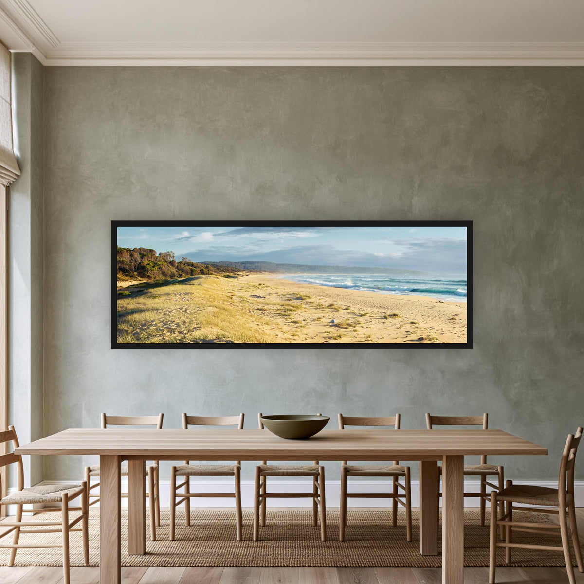 Bournda Beach super wide panorama in a black frame above a timber dining table — wall art, Sapphire Coast NSW