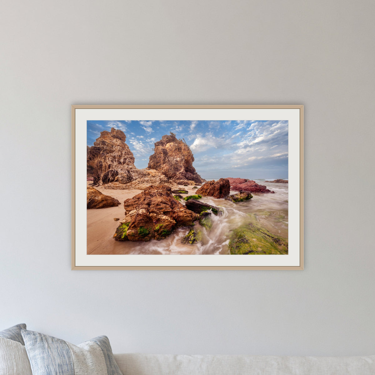 Pambula Rocks framed print in oak with a white mat, in a lounge room