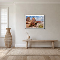 Pambula Rocks framed print in black with a white mat, in a hallway