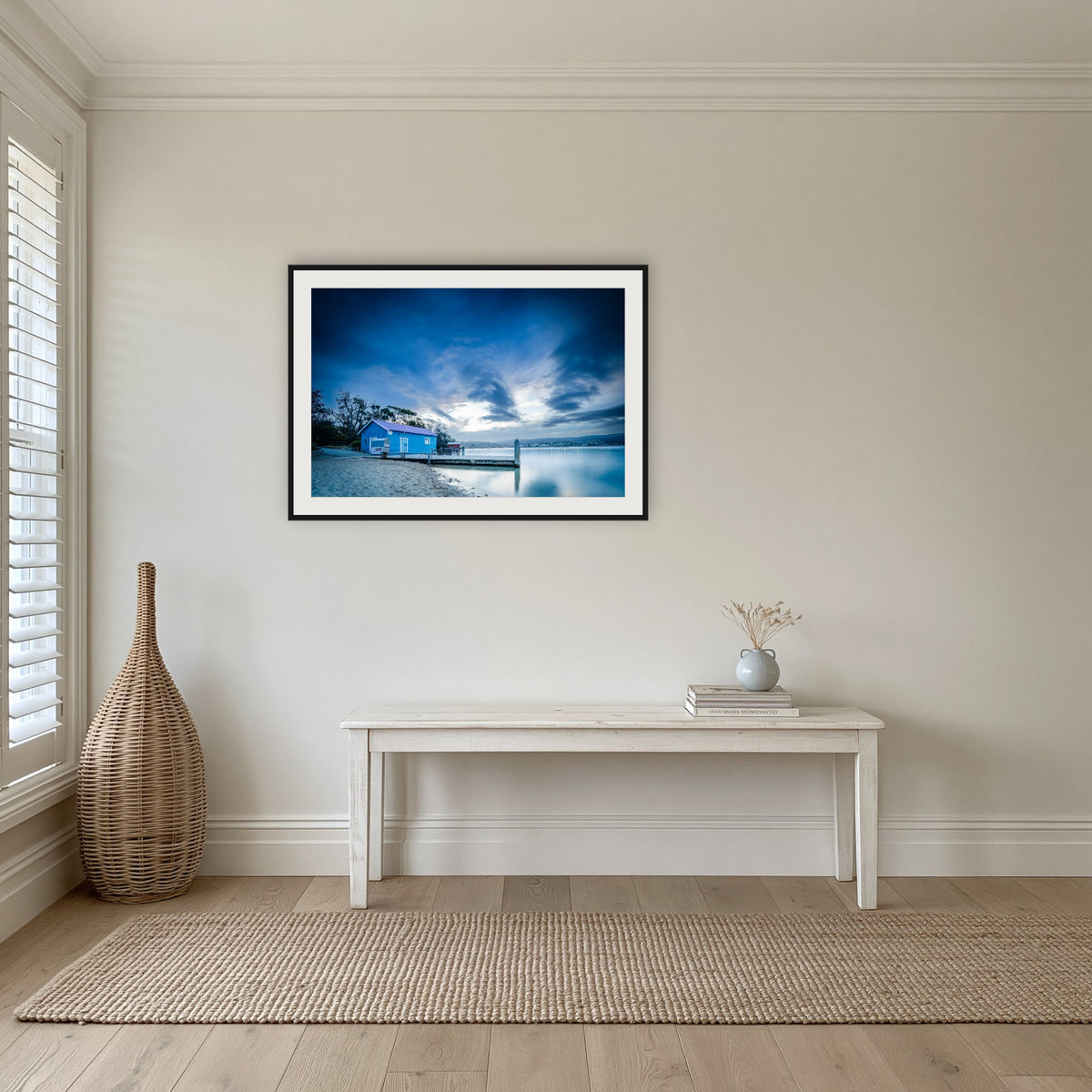 Mitchies Jetty at Dusk, Smooth Lake framed print in black with a white mat, in a hallway