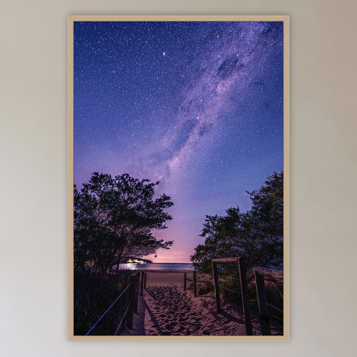 Main Beach Milky Way in an oak frame without a mat, in a cane-panelled hallway