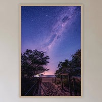 Main Beach Milky Way in an oak frame without a mat, in a cane-panelled hallway