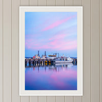 Eden Wharf Tugs framed print in white with a mat, on a panelled hallway wall