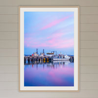 Eden Wharf Tugs framed print in oak with a white mat, in a coastal lounge room