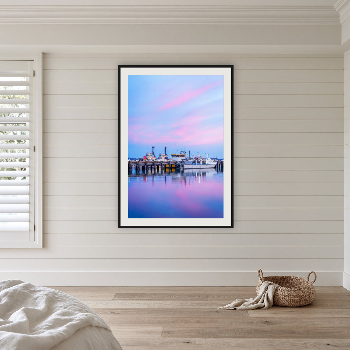 Eden Wharf Tugs framed print in black with a white mat, in a coastal bedroom