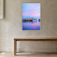 Eden Wharf Tugs in an oak frame without a mat, in a plaster-walled hallway