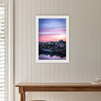 Eden Showtime framed print in white with a mat, on a panelled hallway wall