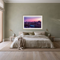 Eden Twofold Hush framed print in oak with a white mat, above a linen bed against a sage wall in a bedroom