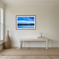 Dawn over Merimbula Lake framed print in black with a white mat, in a hallway
