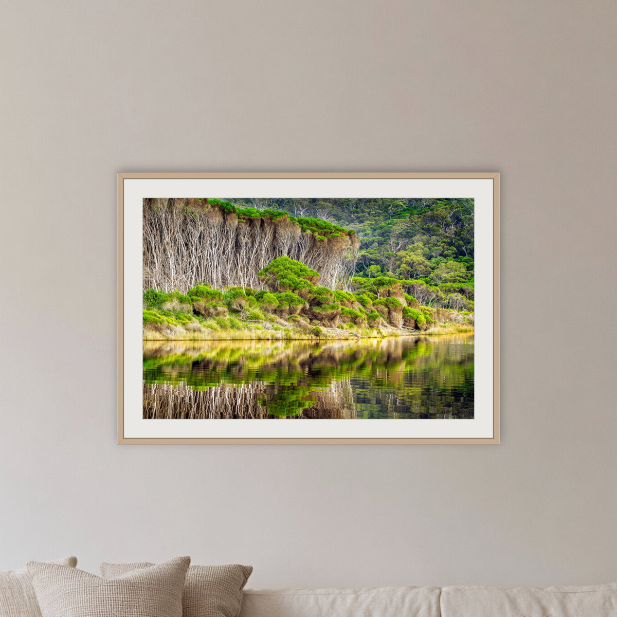 Bournda Lagoon's Serenity framed print in oak with a white mat, in a coastal lounge room