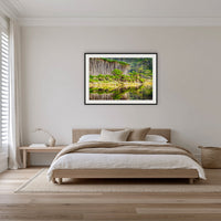 Bournda Lagoon's Serenity framed print in black with a white mat, on a coastal bedroom wall