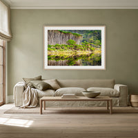 Bournda Lagoon's Serenity framed print in oak with a white mat, above a linen sofa against a sage wall in a lounge room