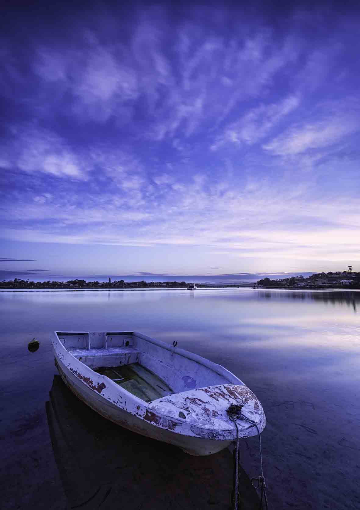 Little dinghy moored on Merimbula Lake at violet sunset, NSW Sapphire Coast — canvas print