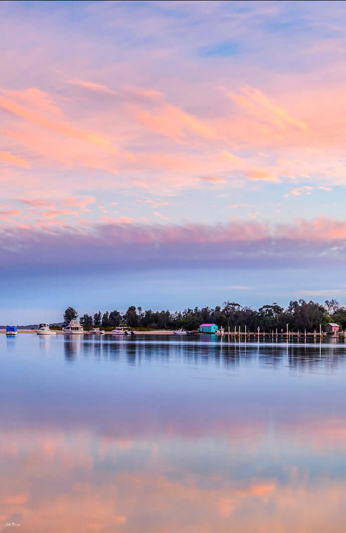 Pastel pink Merimbula Lake sunset print, Mitchies Jetty boatshed reflected in water