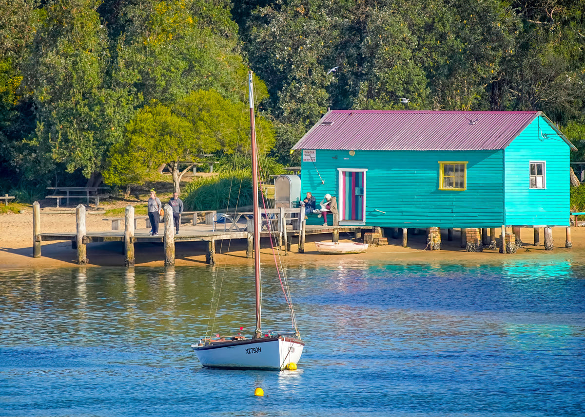 Mitchies Jetty, Merimbula NSW — turquoise boatshed, timber jetty and moored yacht on Merimbula Lake